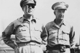 Gen. Douglas MacArthur, left, enjoying his fames corncob pipe, meets Lt. Gen. Robert L. Eichelberger, commanding General eighth army, right, after General MacArthur's arrival Aug. 30, 1945 at Atsugi Airport near Tokyo.