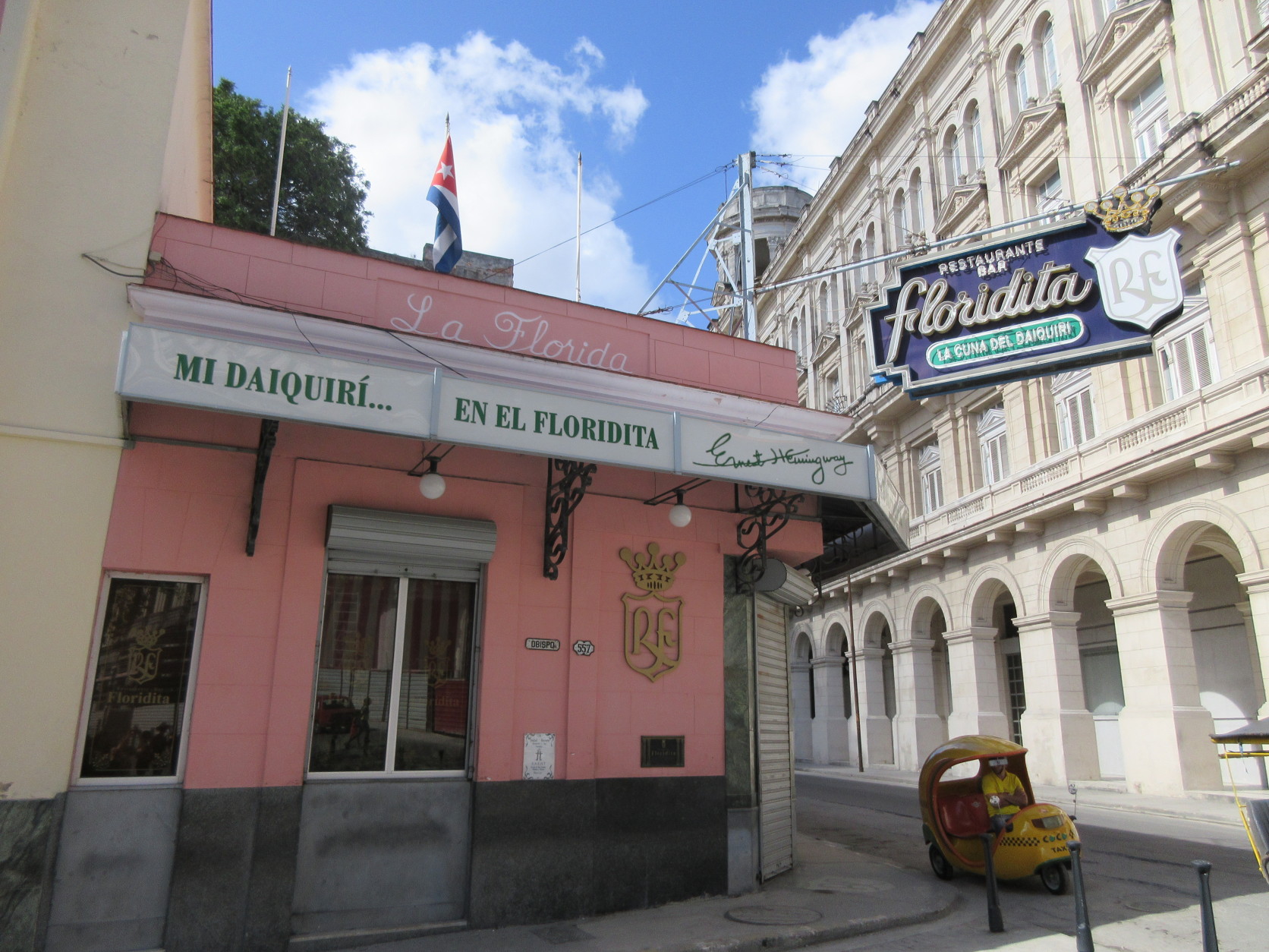 This May 16, 2015 photo shows the exterior of El Floridita, a bar and restaurant frequented by Ernest Hemingway that's a popular stop for tourists in Old Havana, Cuba. The local great air-conditioning, icy daiquiris and a bust of Hemingway, perfect for selfies. (AP Photo/Beth J. Harpaz)