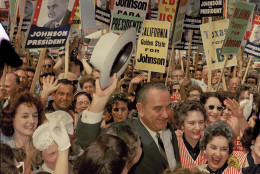 In 1965, President Lyndon B. Johnson signed the Voting Rights Act. Here, Johnson is seen surrounded by supporters as he arrives for the Democratic National Convention in Los Angeles, July 14, 1960.  (AP Photo/Edward Kitch)