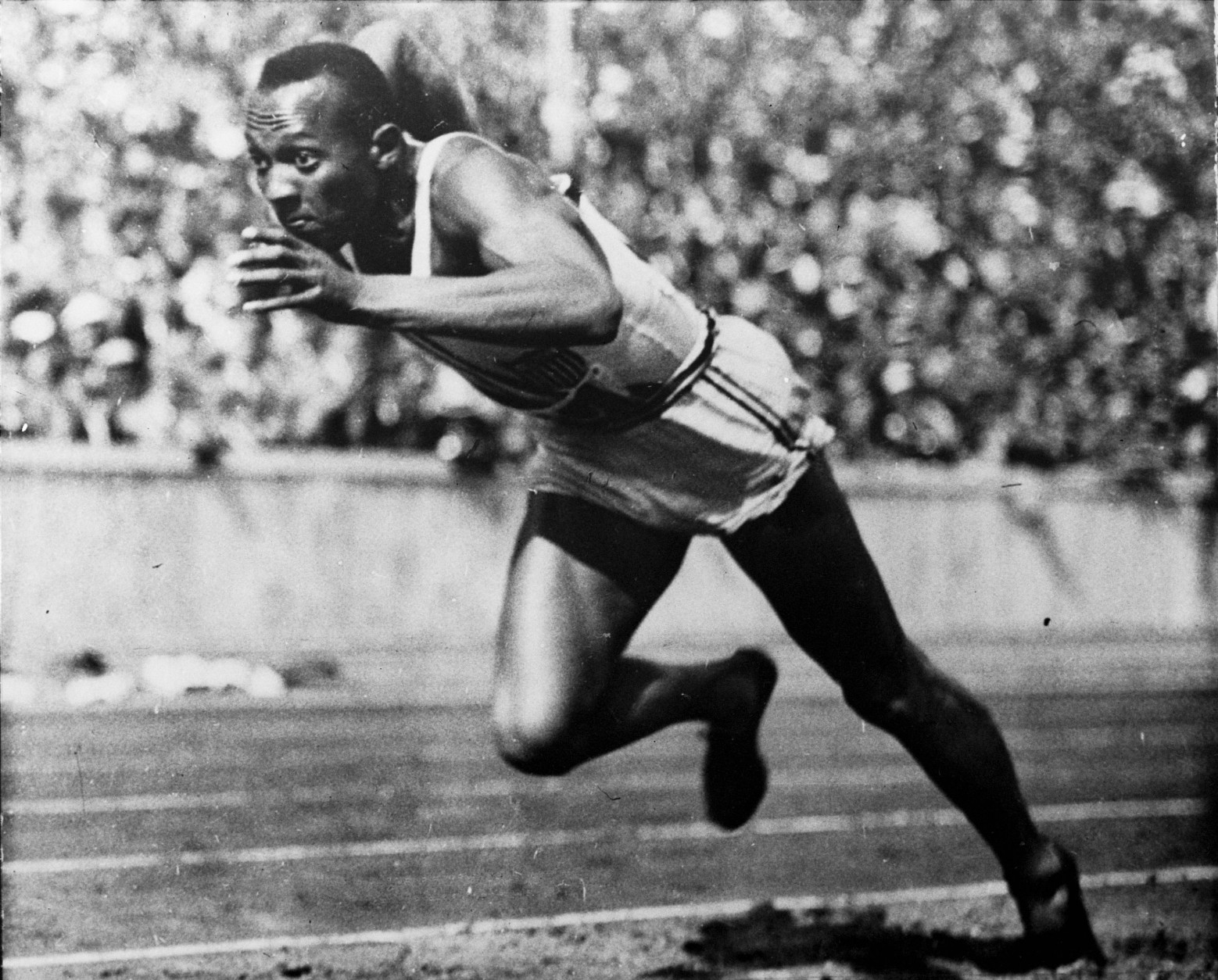 FILE - In this 1936 file photo, Jesse Owens of the United States runs in a 200-meter preliminary heat at the 1936 Summer Olympics in Berlin. Owens won four gold medals at the 1936 Berlin Olympics and showed up Adolph Hitler's idea of Aryan supremacy. The Olympic games are supposed to rise above political interests, but an undertone of politics has been present at every Olympics going back at least to the 1936 games. (AP Photo/File)