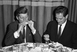 U.S. Sen. John Kennedy, the Democratic presidential nominee, bites into some Iowa sweet corn at a home-style dinner in Des Moines, August 21, 1960 in Illinois. He and his running mate, Sen. Lyndon Johnson were in this city of the farm belt to tell how they would improve the agriculture situation. (AP Photo)