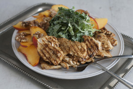 This July 21, 2014 photo shows grilled chicken paillard with peach and arugula salad in Concord, N.H. Chicken paillard serves as an alternative summer dish that is light, refreshing and substantial. (AP Photo/Matthew Mead)