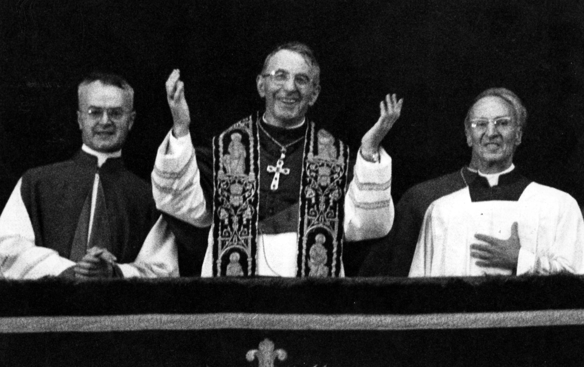 Pope John Paul I smiles and waves with both hands to crowd filling St. Peter's Square Aug. 26, 1978 when the former patriarch of Venice appeared on the balcony of St. Peter's Basilica, short time after the white smoke coming out of the chimney of the Sistine Chapel, indicating that the conclavists had elected a successor for Pope Paul VI. He is flanked by Msgr. Virgilio Noe', master of the pontifical office, right, and Msgr. Orazio Cocchetti, left, also of the pontifical ceremonies office. (Ap Photo)