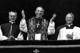 Pope John Paul I smiles and waves with both hands to crowd filling St. Peter's Square Aug. 26, 1978 when the former patriarch of Venice appeared on the balcony of St. Peter's Basilica, short time after the white smoke coming out of the chimney of the Sistine Chapel, indicating that the conclavists had elected a successor for Pope Paul VI. He is flanked by Msgr. Virgilio Noe', master of the pontifical office, right, and Msgr. Orazio Cocchetti, left, also of the pontifical ceremonies office. (Ap Photo)