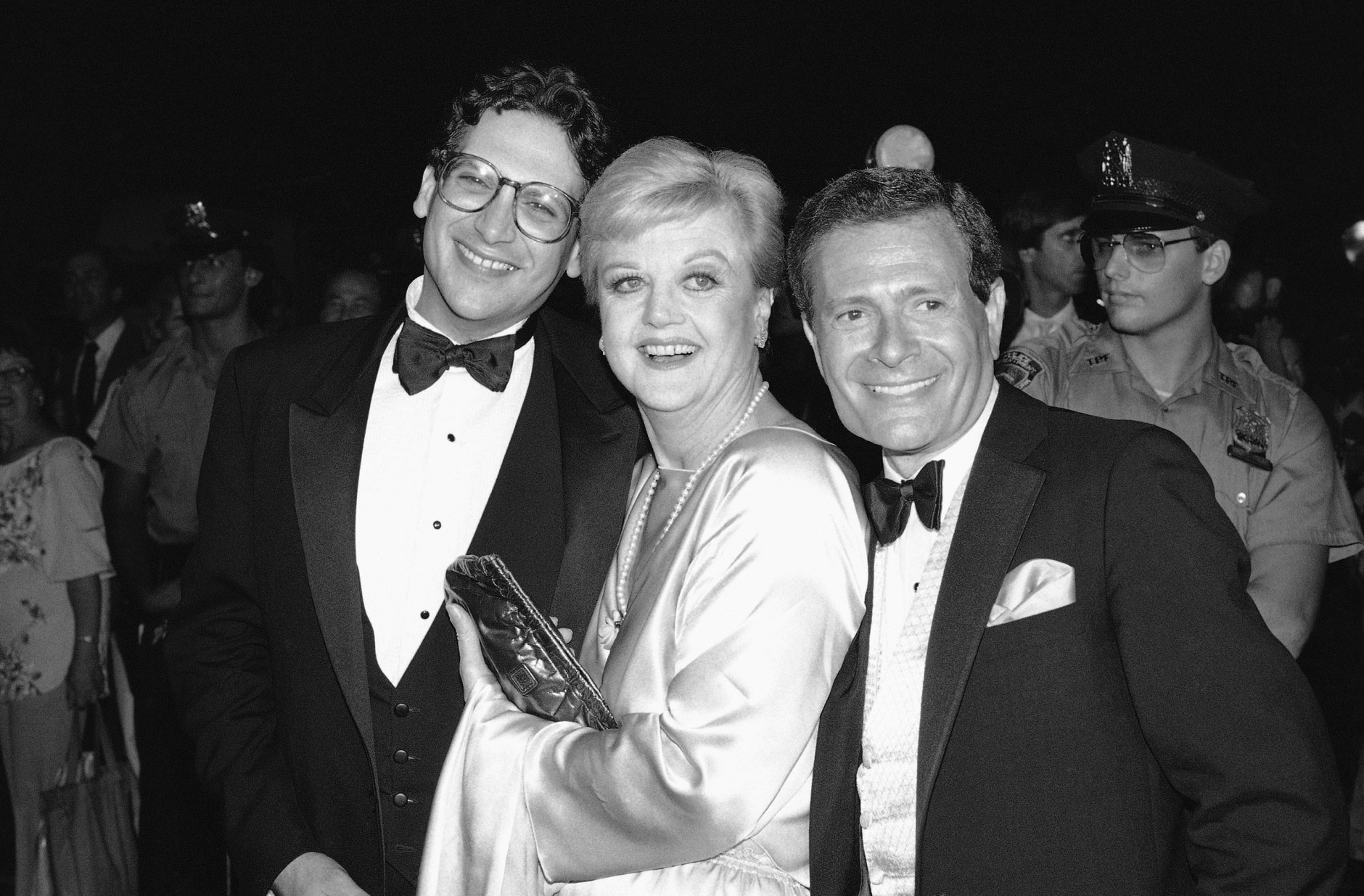 Actress Angela Lansbury, center, poses with actor-author Harvey Fierstein, left, and composer-Lyricist Jerry Herman, Sunday, August 21, 1983 in New York at the Broadway opening party for the play La Cage Aux Folles." Fierstein wrote the book La Cage Aux Folles, and Herman authored the music and Lyrics for the Broadway musical Mame. (AP Photo/Rene Perez)