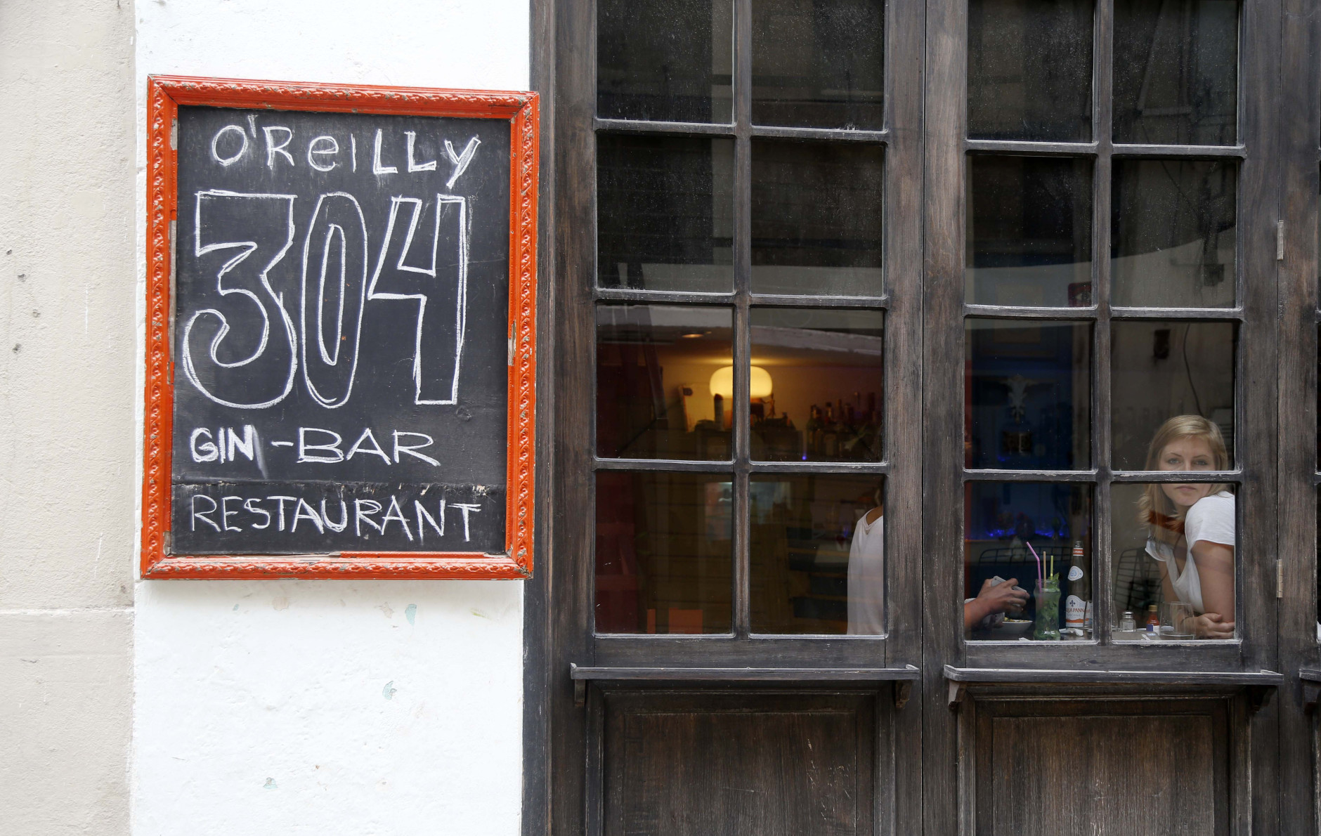 Tourists eat at the paladar O'Reilly 304 in Old Havana, Cuba, Monday, June 1, 2015. When eating in Havana, stick to "paladares" - privately owned restaurants. You'll need reservations for the best. Prices are moderate but not cheap. (AP Photo/Desmond Boylan)