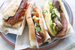 This June 29, 2013 photo shows, from left, the Italian, sweet peach and Hawaiian hot dogs in Concord, N.H. (AP Photo/Matthew Mead)