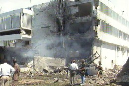 Smoke rises from the U.S. Embassy in Dar es Salaam, Tanzania, in this frame grabe from television, after a suspected car bomb exploded outside it Friday Aug. 7 1998.  Reports said that at least nine people were killed and 16 were injured in the blast. There was also an explosion outside the U.S. Embassy in Nairobi, Kenya, at the same time, causing extensive damage and killing more than people. (AP Photo / APTV)  TANZANIA OUT - TV OUT