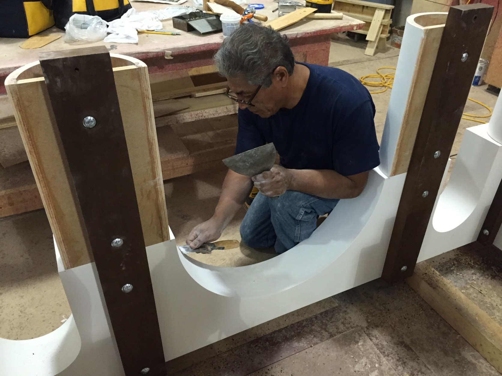 One of Cahoon's workers constructs some of the furniture for Pope Francis' Sept. 23 mass. (WTOP/Andrew Mollenbeck)