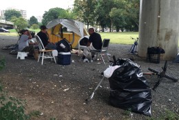 Dozens of homeless camps are scattered throughout Washington, D.C. Here, a group of men sit under a bridge along Rock Creek Parkway in Northwest. (WTOP/Andrew Mollenbeck)