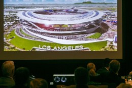 An architectural rendering for a new NFL stadium is projected during a lunch sponsored by the Los Angeles Sports Council downtown Los Angeles Monday, Aug. 17, 2015. The $1.7-billion new NFL football stadium proposed for Carson by the owners of the San Diego Chargers and Oakland Raiders will be located 15 miles from West Los Angeles, 10 miles from Orange County and 12 miles from downtown. The stadium's capacity will be 65,000 and can be increased to 75,000 for the Super Bowl. (AP Photo/Damian Dovarganes)