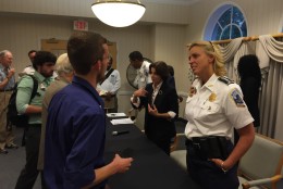 D.C. Police Chief Cathy Lanier spoke one-on-one with several people at the end of a community meeting Monday at Forest Hills Senior Living Center in Northwest. (WTOP/Michelle Basch)