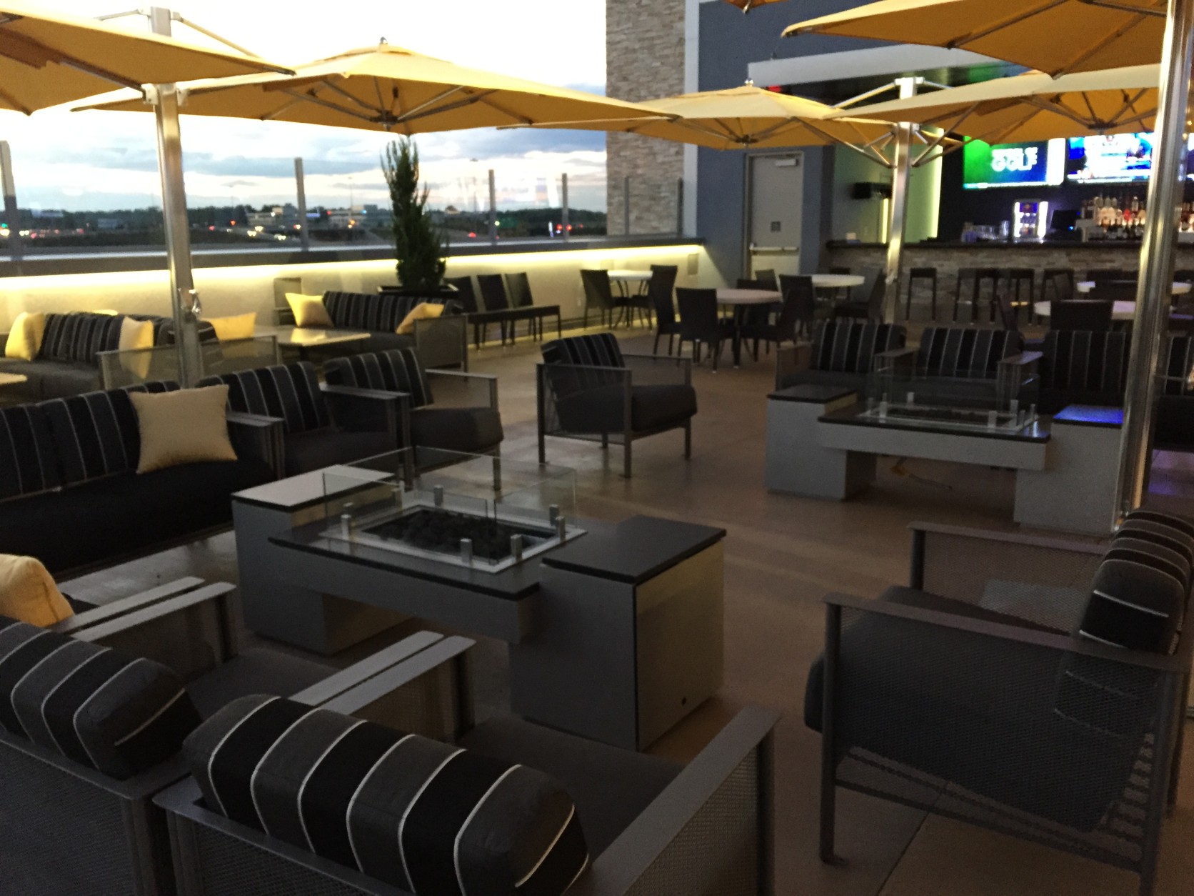 The rooftop terrace (on the third level) has a bar, a stage for a DJ and two fire pits. (WTOP/Michelle Basch)
