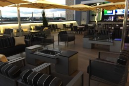 The rooftop terrace (on the third level) has a bar, a stage for a DJ and two fire pits. (WTOP/Michelle Basch)