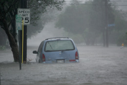 Floodwaters surround a car in uptown New Orleans early Monday, Aug. 29, 2005 as high winds and rain batter the Louisiana coast as Hurricane Katrina makes landfall. (AP Photo/Dave Martin)