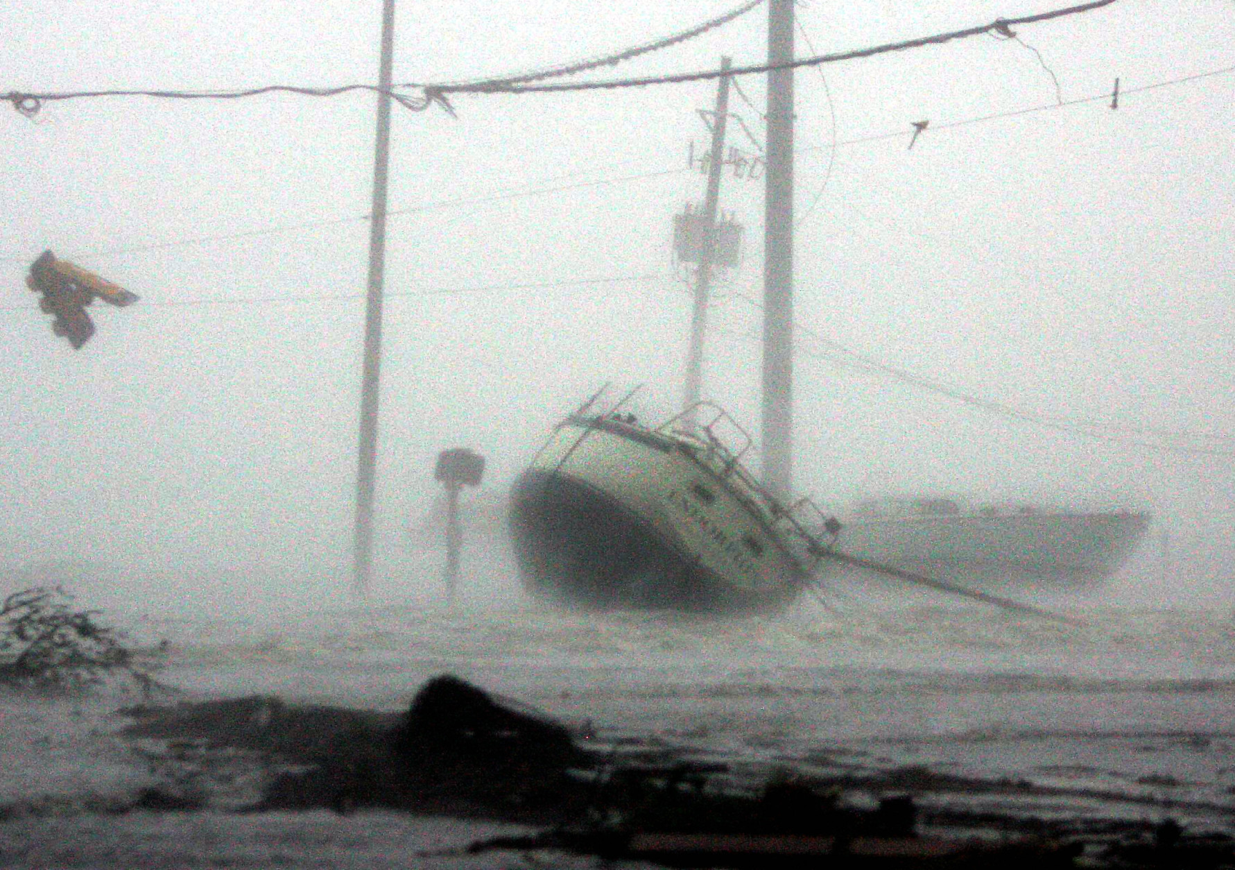 Waves crash against a boat washed onto Highway 90 as Hurricane Katrina hits the Gulf Coast Monday,  Aug. 29, 2005 in Gulfport, Miss.  (AP Photo/John Bazemore)