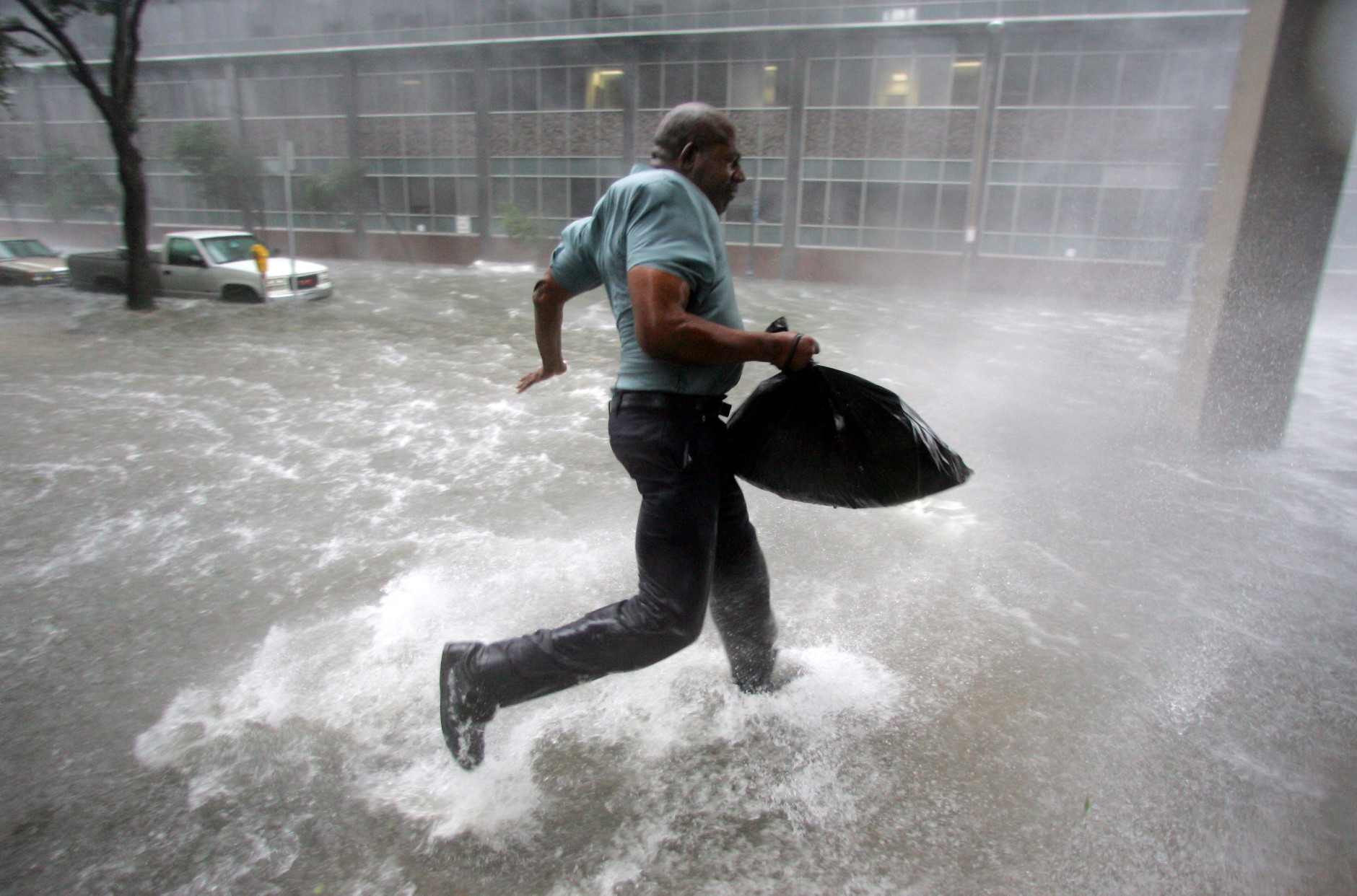 Arnold James tries to keep his feet as a strong gust nearly blows him over as he tries to make his way on foot to the Louisiana Superdome in New Orleans on Monday, Aug. 29, 2005.  The roof on James's home blew off, forcing him to seek shelter at the Superdome. (AP Photo/Dave Martin)