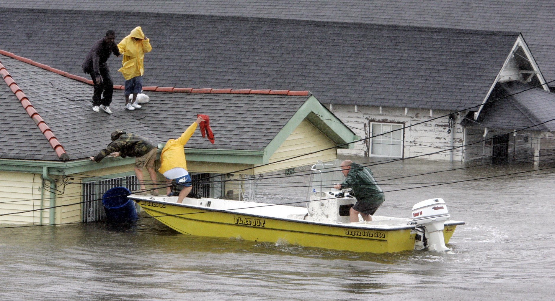 Bryan Vernon and Dorothy Bell are rescued from their  rooftop after  Hurricane Katrina hit, causing flooding in their New Orleans neighborhood,  Monday Morning, Aug. 29,  2005. Officials called for a mandatory evacuation of the city, but many residents remained in the city.  (AP Photo/Eric Gay)