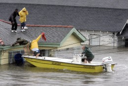 Bryan Vernon and Dorothy Bell are rescued from their  rooftop after  Hurricane Katrina hit, causing flooding in their New Orleans neighborhood,  Monday Morning, Aug. 29,  2005. Officials called for a mandatory evacuation of the city, but many residents remained in the city.  (AP Photo/Eric Gay)