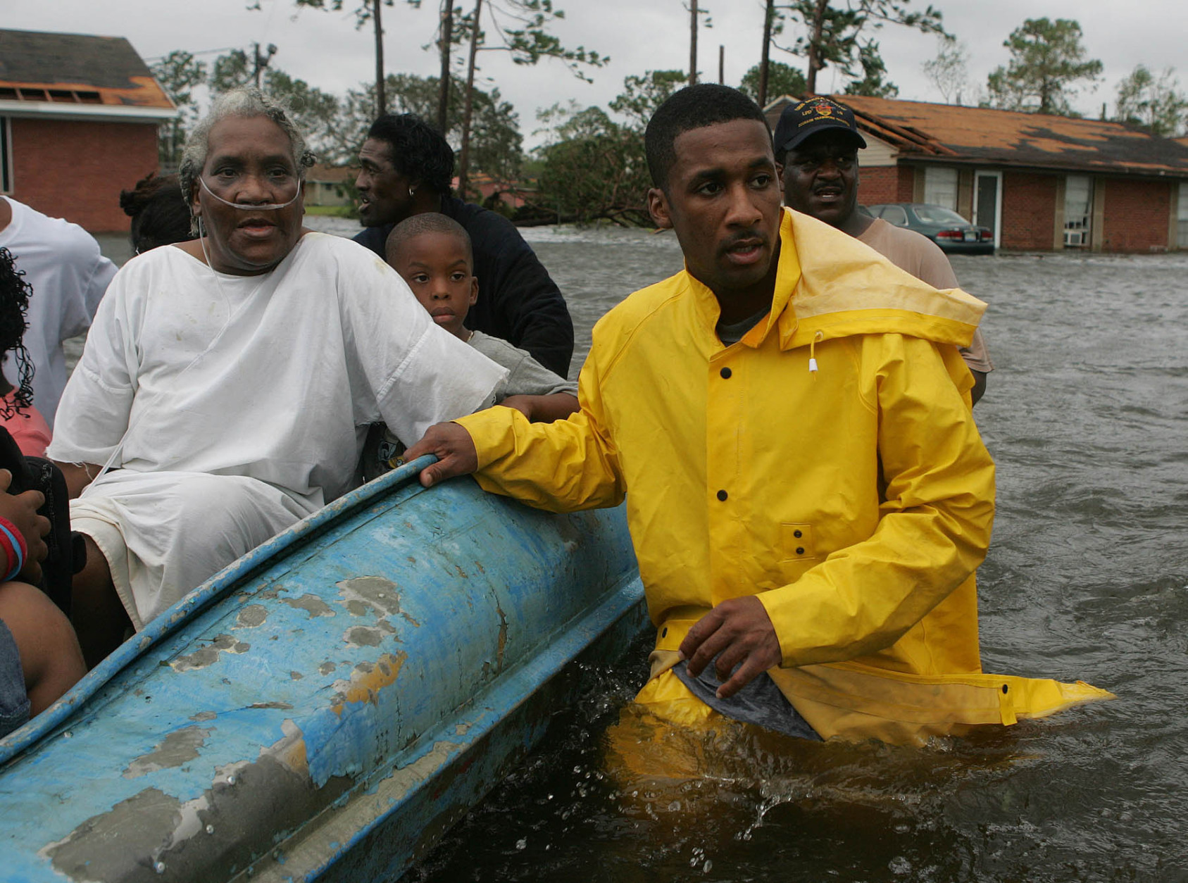 Gulfport Miss. Police Officer Terrence Gray, right, helps evacuate Lovie Mae Allen and group of children from their flooded homes after Hurricane Katrina struck the Gulf Coast Monday,  Aug. 29, 2005 in Gulfport, Miss. (AP Photo/John Bazemore)