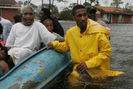 Gulfport Miss. Police Officer Terrence Gray, right, helps evacuate Lovie Mae Allen and group of children from their flooded homes after Hurricane Katrina struck the Gulf Coast Monday,  Aug. 29, 2005 in Gulfport, Miss. (AP Photo/John Bazemore)