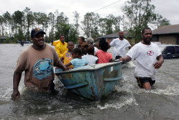 Rescuers use an old row boat to evacuate children and an elderly woman from their flooded homes in Gulfport, Miss., after  Hurricane Katrina struck the Gulf Coast Monday,  Aug. 29, 2005.  (AP Photo/John Bazemore)
