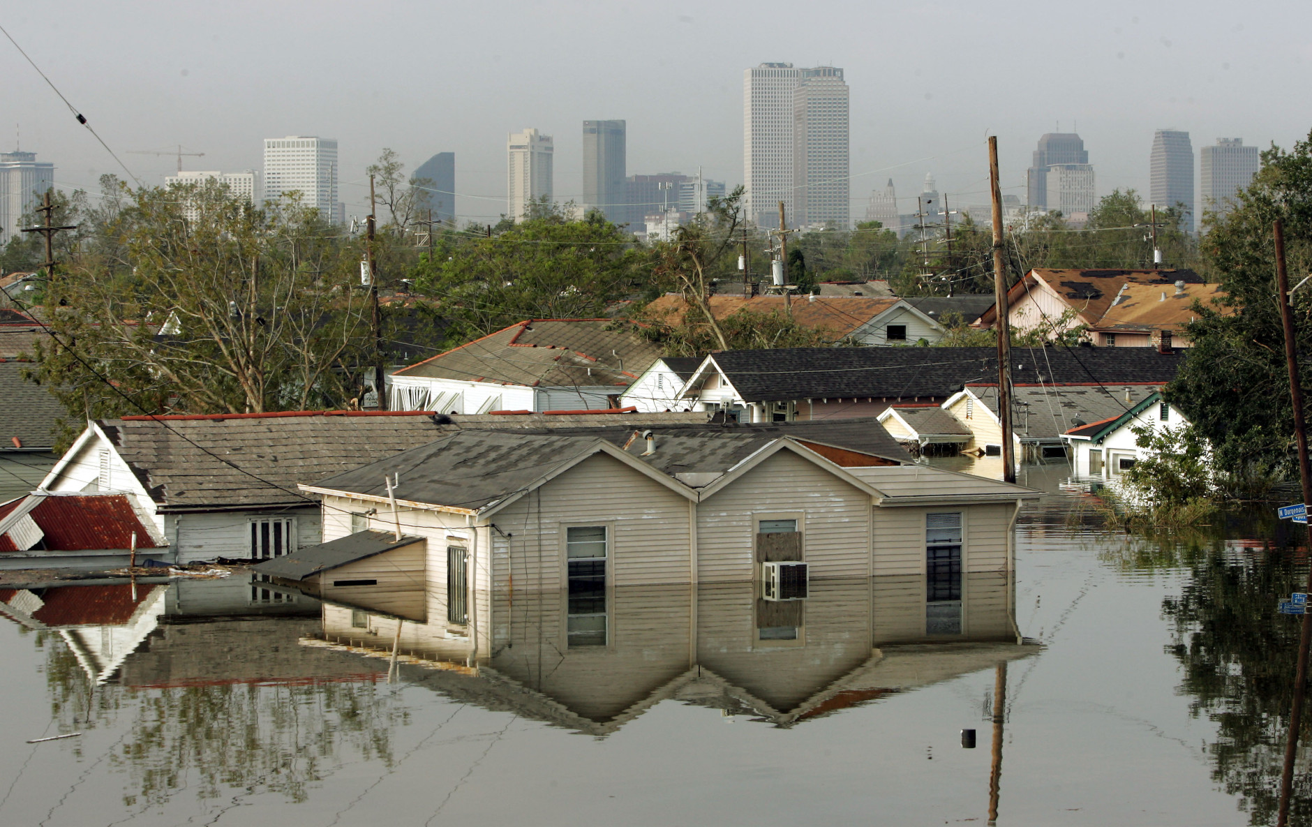 Houses in New Orleans 8th Ward are surrounded by water in the flooded city of New Orleans on Tuesday, Aug. 30, 2005. Water continues to rise after the onslaught of Hurricane Katrina which pounded the coast on Monday. (AP Photo/Dave Martin)