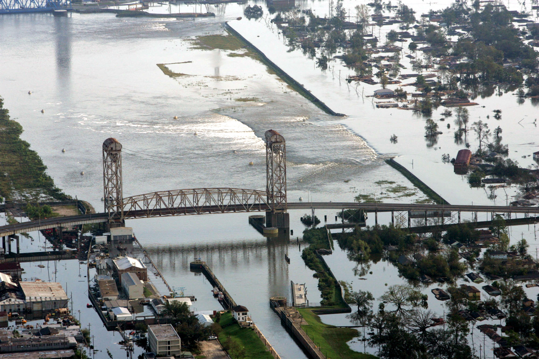 Floodwaters from Hurricane Katrina flow over a levee along Inner Harbor Navigaional Canal near downtown New Orleans Tuesday, Aug. 30, 2005. Hurricane Katrina did extensive damage when it made landfall on Monday. (AP Photo/David J. Phillip)