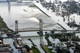 Floodwaters from Hurricane Katrina flow over a levee along Inner Harbor Navigaional Canal near downtown New Orleans Tuesday, Aug. 30, 2005. Hurricane Katrina did extensive damage when it made landfall on Monday. (AP Photo/David J. Phillip)