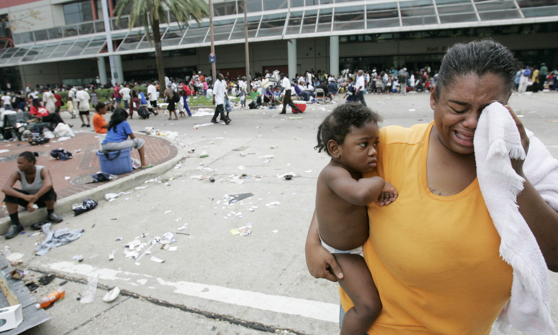 A woman cries as she waits with other flood victims at the Convention Center in New Orleans, Thursday, Sept. 1, 2005.  Officials called for a mandatory evacuation of the city, but many residents remained in the city and had to be rescued from flooded homes and hotels and remain in the city awaiting a way out.  (AP Photo/Eric Gay)