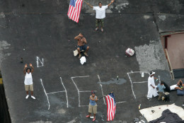Residents wait on a rooftop to be rescued from the floodwaters of  Hurricane Katrina Thursday, Sept. 1, 2005 in New Orleans. (AP Photo/David J. Phillip, Pool)