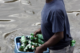 A looter carries a bucket of beer out of a grocery store in New Orleans on Tuesday, Aug. 30, 2005, as floodwaters continue to rise in New Orleans after Hurricane Katrina made landfall on Monday. (AP Photo/Dave Martin)
