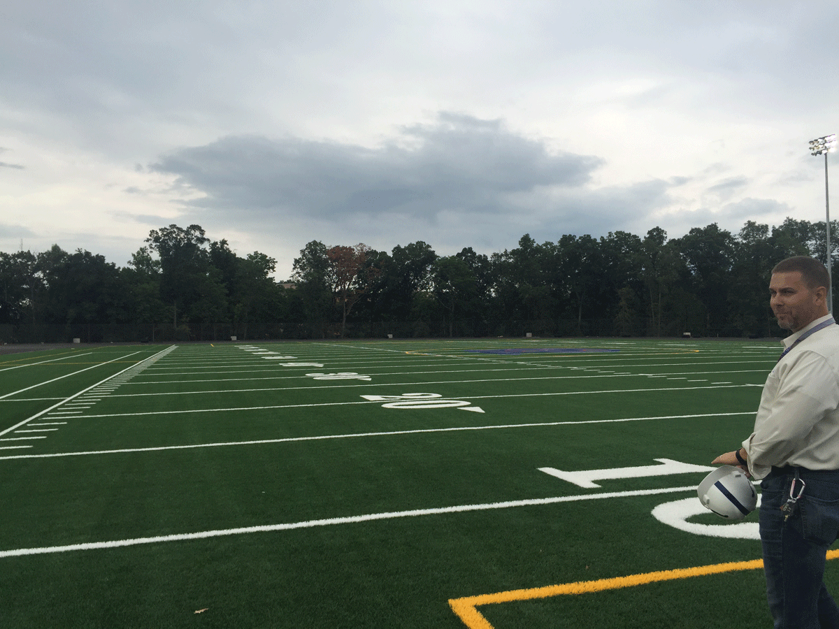 Principal Doug Anderson looking over the new football field.  (WTOP/Max Smith)