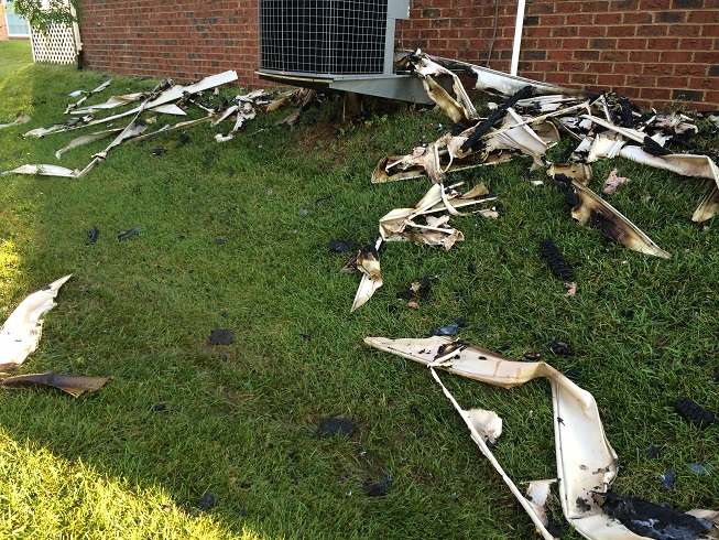 Debris lines the yard of a Marriottsville house that burned after it was struck by lightning in Tuesday morning's storms. (WTOP/Nick Iannelli)