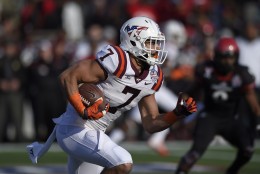 Virginia Tech tight end Bucky Hodges (7) carries the ball against Cincinnati during the first half of the Military Bowl NCAA college football game, Saturday, Dec. 27, 2014, in Annapolis, Md. (AP Photo/Nick Wass)