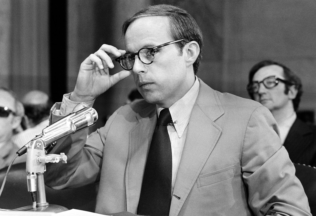John Dean III, former White House aide in the Nixon Administration, adjusts his eyeglasses as he nears the end of reading his 245-page prepared statement before the Senate Watergate Committee in Washington, D.C., on June 25, 1973. In his seven-hour opening statement Dean said that the president was involved in the cover-up of the Watergate burglary. (AP Photo)