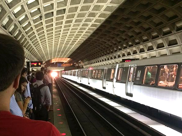 Metro riders crowd onto the platform at Farragut West waiting for a spot on a packed train. (WTOP/Mike Murillo)