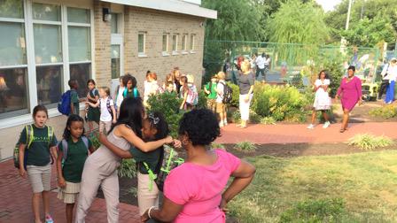 JoAnn Hill welcomes River Adams to Brent Elementary for the first day of school. (Photo: WTOP/Kristi King)