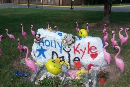 A memorial was set up for Kyle Mathers, Dale Neibaur and Holly Novak at Herndon High. (WTOP/Rahul Bali)