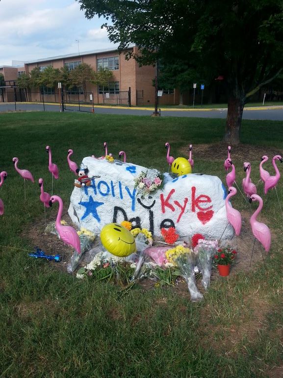 A memorial was set up for Kyle Mathers, Dale Neibaur and Holly Novak at Herndon High. (WTOP/Rahul Bali)