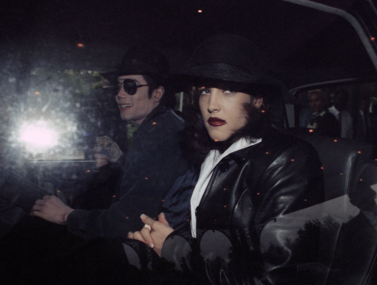 On this day in 1994, pop icon Michael Jackson and Lisa Marie Presley, daughter of Elivis, confirm they were secretly wed 11 weeks before. Here, Jackson and Presley leave a hotel at Euro Disneyland, Paris, on Sept. 5, 1994. (AP Photo)