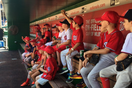 Some of the 100 young baseball players who sent the day with members of the Nationals ask questions of teammates at Nationals Park. (WTOP/Andrew Mollenbeck)