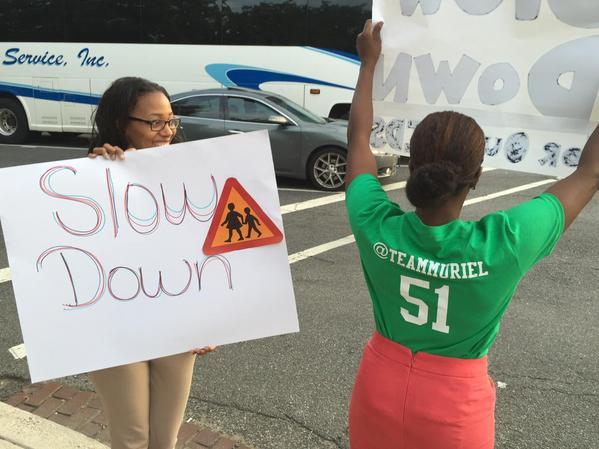 People participate in Mayor Muriel Bowser's "Slow Down" campaign as kids return for the first day of school. (Photo: WTOP/Kristi King)
