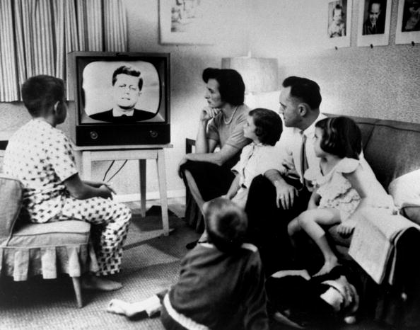 Typical American family gathered around TV, which displays John F. Kennedy's face, to watch debate between Kennedy &amp; Richard Nixon during presidential election.  (Photo by Time Life Pictures/National Archives/The LIFE Picture Collection/Getty Images)