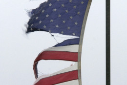 A tattered American Flag flaps in the strong  wind and rain of Hurricane Isabel in the Sandbridge area of Virginia Beach, Va., Thursday Sept. 18, 2003. Hurricane Isabel is expected to make landfall later in the day.   (AP Photo/Steve Helber)