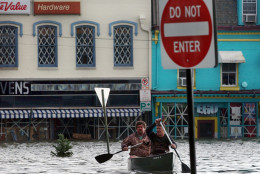 Mark Bateman, left, and Sveinn Storm, right, take a morning boat ride through a flooded downton Annapolis, Friday, Sept. 19, 2003.  Storm's ice cream store in Annapolis was totally flooded as the rain and storm surge from Hurricane Isabel pushed water into low-lying areas.  Tidal surges up to 7 feet were expected in some areas of southern Maryland, where high tides began late in the night. (AP Photo/Susan Walsh)