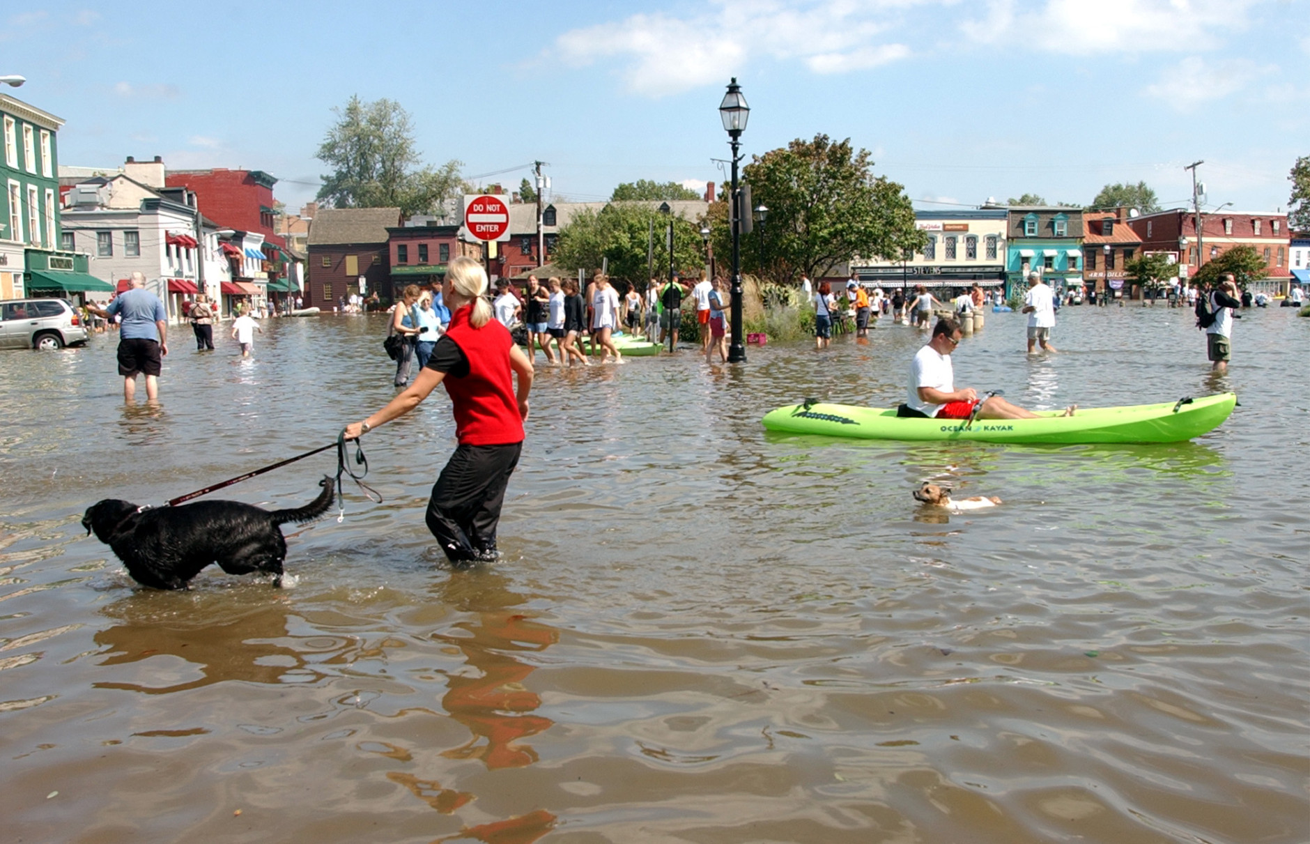 Dozens of people gather in flooded downton Annapolis, Md., Friday, Sept. 19, 2003, to see the water damage from Hurricane Isabel. Rising tides fed by high winds and rains from Isabel pushed water inland to low-lying areas around the Chesapeake Bay and Potomac River early Friday, flooding homes and businesses. (AP Photo/Susan Walsh)