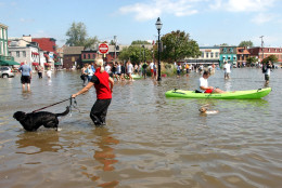 Dozens of people gather in flooded downton Annapolis, Md., Friday, Sept. 19, 2003, to see the water damage from Hurricane Isabel. Rising tides fed by high winds and rains from Isabel pushed water inland to low-lying areas around the Chesapeake Bay and Potomac River early Friday, flooding homes and businesses. (AP Photo/Susan Walsh)