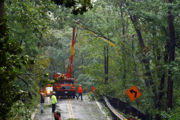 Maryland State Highway crews and employees of R&amp;K Tree services remove downed trees Friday, Sept. 19, 2003 along Maryland 77 west of Thurmont, Md., in the aftermath of Hurricane Isabel. The 10-mile section of mountainous road near Camp David was one of only a few hard hit areas in Frederick County. (AP Photo/Timothy Jacobsen)