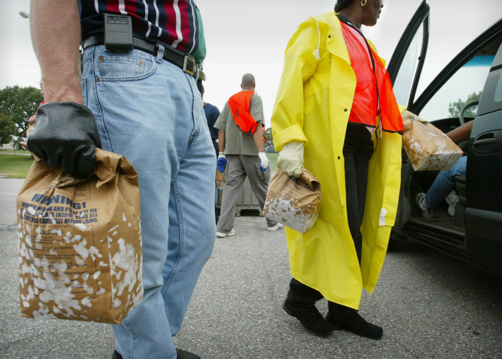 Pepco employees help distribute dry ice to local residents from the parking lot of RFK Stadium in Washington, Friday, Sept. 19, 2003, after Tropical Storm Isabel knocked out power to some 531,000 customers in the District of Columbia; Montgomery County, Md., and Prince George's County, Md. Pepco ran out of ice at some distribution sites saying there was only one dry ice producer in the region, and their power was out most of the day. (AP Photo/Lawrence Jackson)